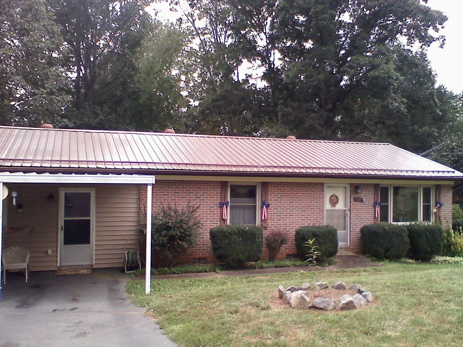 Bronze metal roof and carport on a brick ranch home — Roof Repair work by our crew in Obernburg